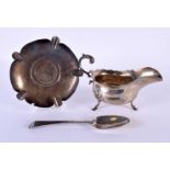 A SILVER SAUCEBOAT together with a silver spoon and a silver ashtray. 468 grams. Sheffield 1904 to