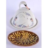 AN UNUSUAL STUDIO POTTERY SWAN CHEESE DOME AND COVER together with a treacle glazed slip ware