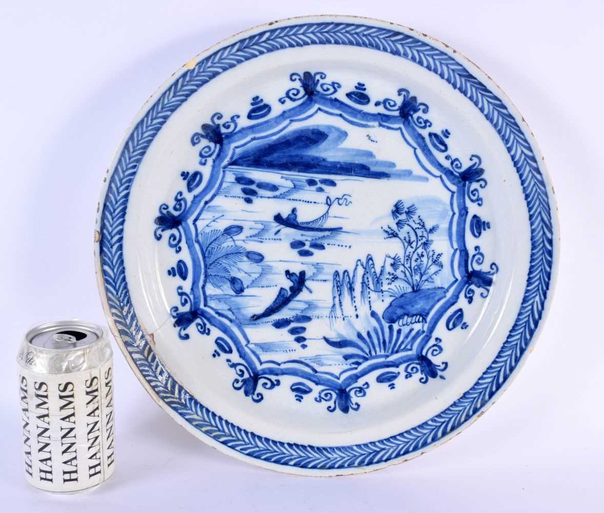 A LARGE 18TH CENTURY DUTCH DELFT BLUE AND WHITE DISH painted with figures on boats. 33 cm diameter.