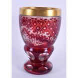 AN ANTIQUE BOHEMIAN RUBY GLASS BEAKER decorated with foliage. 13 cm x 8 cm.