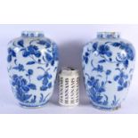 A PAIR OF 18TH CENTURY DUTCH DELFT BLUE AND WHITE TIN GLAZED VASES painted with flowers. 24 cm x