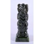 A NEW ZEALAND TRIBAL CARVED JADE MAORI IDOL upon a square form base. 8 cm x 2 cm.