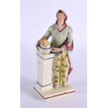 A LATE 18TH/19TH CENTURY ENGLISH POTTERY FIGURE OF A FEMALE modelled beside a column. 15 cm high.