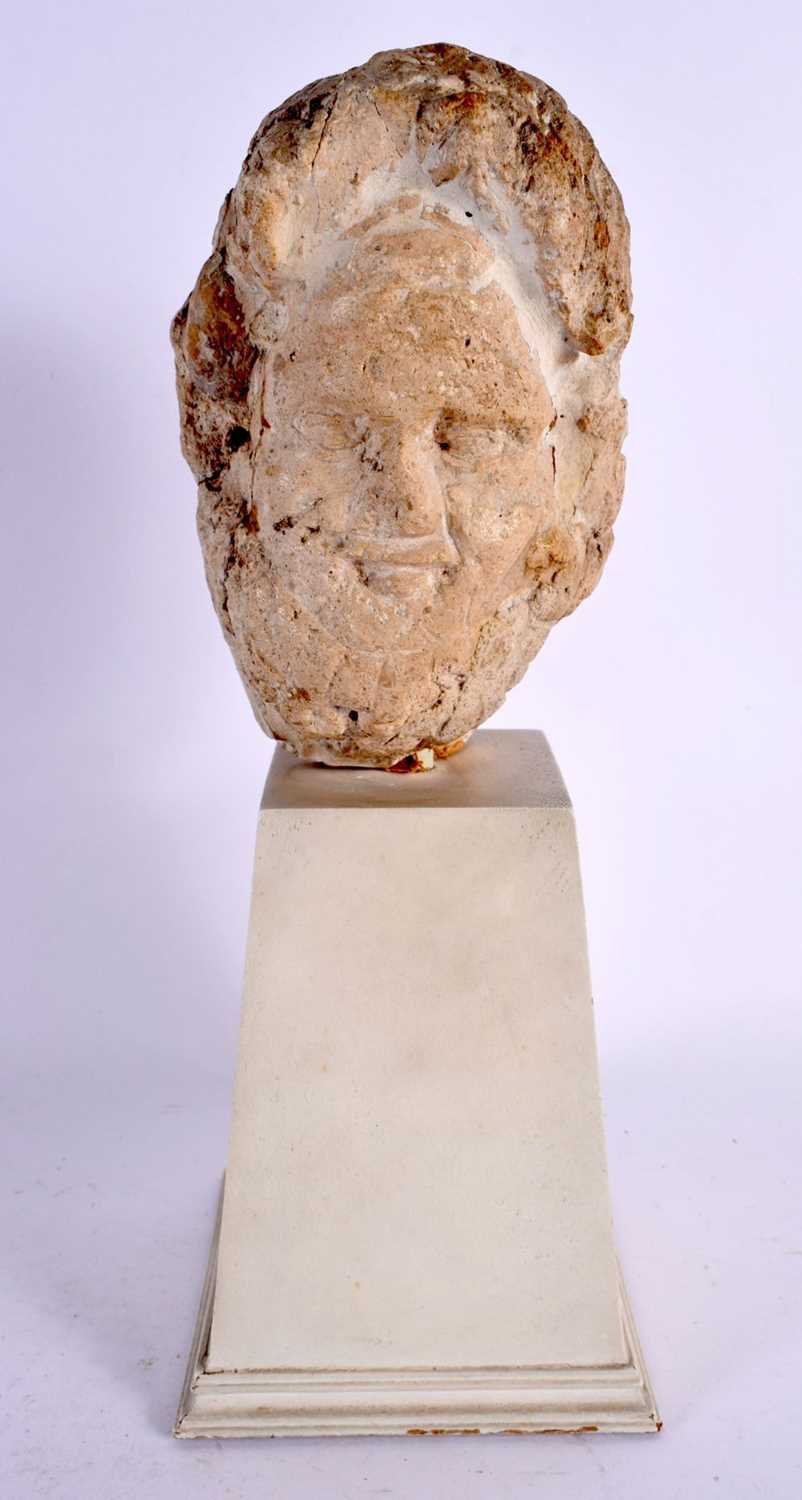 A RARE ROMANO BRITISH CARVED LIMESTONE HEAD C200AD depicting an elderly male, upon a white painted