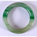 A CHINESE CARVED JADEITE BANGLE 20th Century. 8 cm diameter.