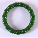 A CHINESE CARVED GREEN JADE BANGLE 20th Century. 7.5 cm diameter.