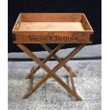 A large wooden Champagne tray on a fitted stand 79 x 65 cm. (2).