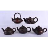 FIVE CHINESE YIXING POTTERY TEAPOT AND COVERS. Largest 15 cm wide. (5)