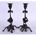 A RARE PAIR OF 19TH CENTURY EUROPEAN BRONZE CANDLESTICKS formed as acrobats. 22.5 cm high.