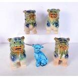 A group of four Chinese pottery dogs, together with a blue glazed dog. (5)