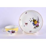 18th century Meissen yellow ground teacup and saucer painted with flower, the teacup with shaped