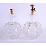 A PAIR OF ANTIQUE GLASS DECANTERS AND STOPPERS decorated with boats and foliage. 25 cm x 12 cm.