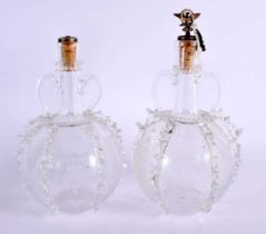 A PAIR OF ANTIQUE GLASS DECANTERS AND STOPPERS decorated with boats and foliage. 25 cm x 12 cm.