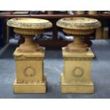 A GOOD PAIR OF 19TH CENTURY EUROPEAN TERRACOTTA URNS ON STANDS of classical form. 80 cm x 36 cm.