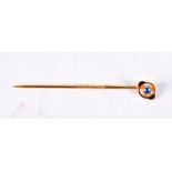 A VICTORIAN 15CT GOLD AND SAPPHIRE STICK PIN. 1 grams. 5.5 cm long.