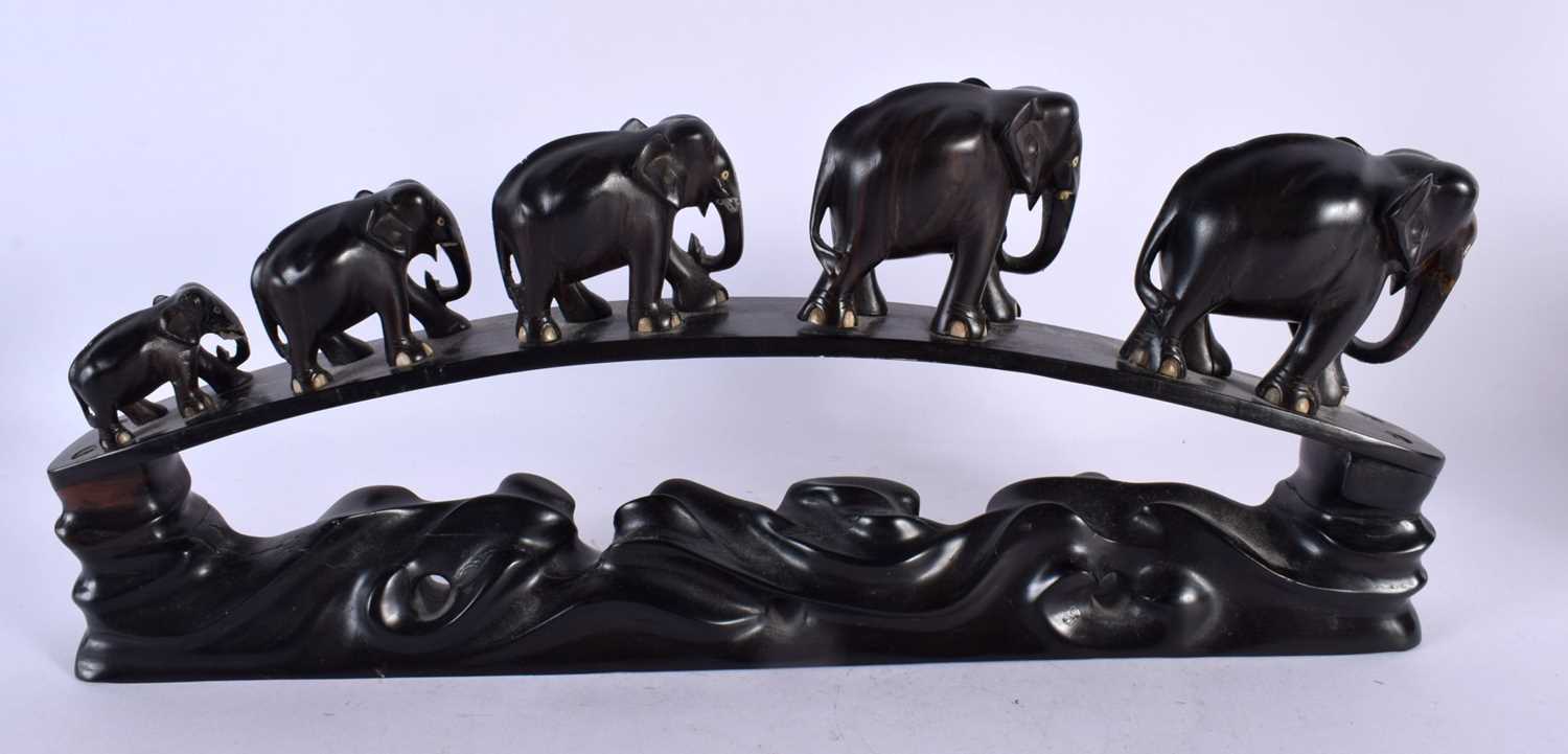 A LATE 19TH CENTURY ANGLO INDIAN CARVED HARDWOOD ELEPHANT GROUP modelled roaming. 45 cm x 20 cm. - Image 5 of 5