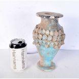 An Islamic blue glazed pottery vase. 23 cm.