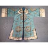 A FINE 19TH CENTURY CHINESE GREEN SILK EMBROIDERED JACKET Qing, decorated with eight roundels and