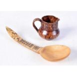 An carved Horn spoon dated 1890 together with a small treacle glazed jug 16 .5 cm.