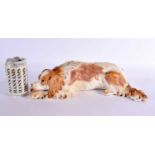 A LARGE 19TH CENTURY CONTINENTAL PORCELAIN FIGURE OF A RECUMBENT DOG possibly Russian. 36 cm long.