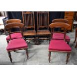 A pair of 19th Century oak hall chairs together with a set of upholstered dining chairs 109 cm (6)