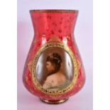 A 19TH CENTURY BOHEMIAN CRANBERRY GLASS VASE painted with a portrait of a female. 15 cm high.