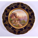Royal Worcester plate painted with an English country cottage and garden by Raymond Rushton, signed,