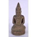 A 19TH CENTURY SOUTH EAST ASIAN CARVED STONE FIGURE OF A BUDDHA modelled with hands clasped upon a