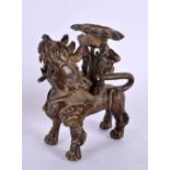 A 17TH/18TH CENTURY SOUTH EAST ASIAN BRONZE CANDLESTICK formed as a scowling beast. 9 cm x 6 cm.