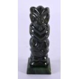 A NEW ZEALAND TRIBAL CARVED JADE MAORI IDOL upon a square form base. 8 cm x 2 cm.