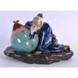 A CHINESE REPUBLICAN PERIOD POTTERY FIGURE OF A MALE enamelled beside a peach. 22 cm x 15 cm.