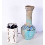An Islamic blue glazed pottery vase. 24 cm.