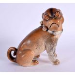 A 19TH CENTURY GERMAN PORCELAIN FIGURE OF A SEATED DOG. 14 cm x 12 cm.