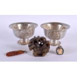 A PAIR OF 19TH CENTURY CHINESE TIBETAN SILVER BOWLS together with an amber fish pendant etc.