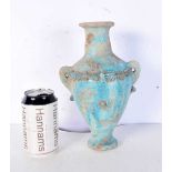 An Islamic blue glazed pottery vase. 30 cm.