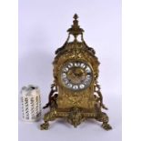 A 19TH CENTURY FRENCH BRONZE MANTEL CLOCK decorated with mask heads. 34 cm x 18 cm.