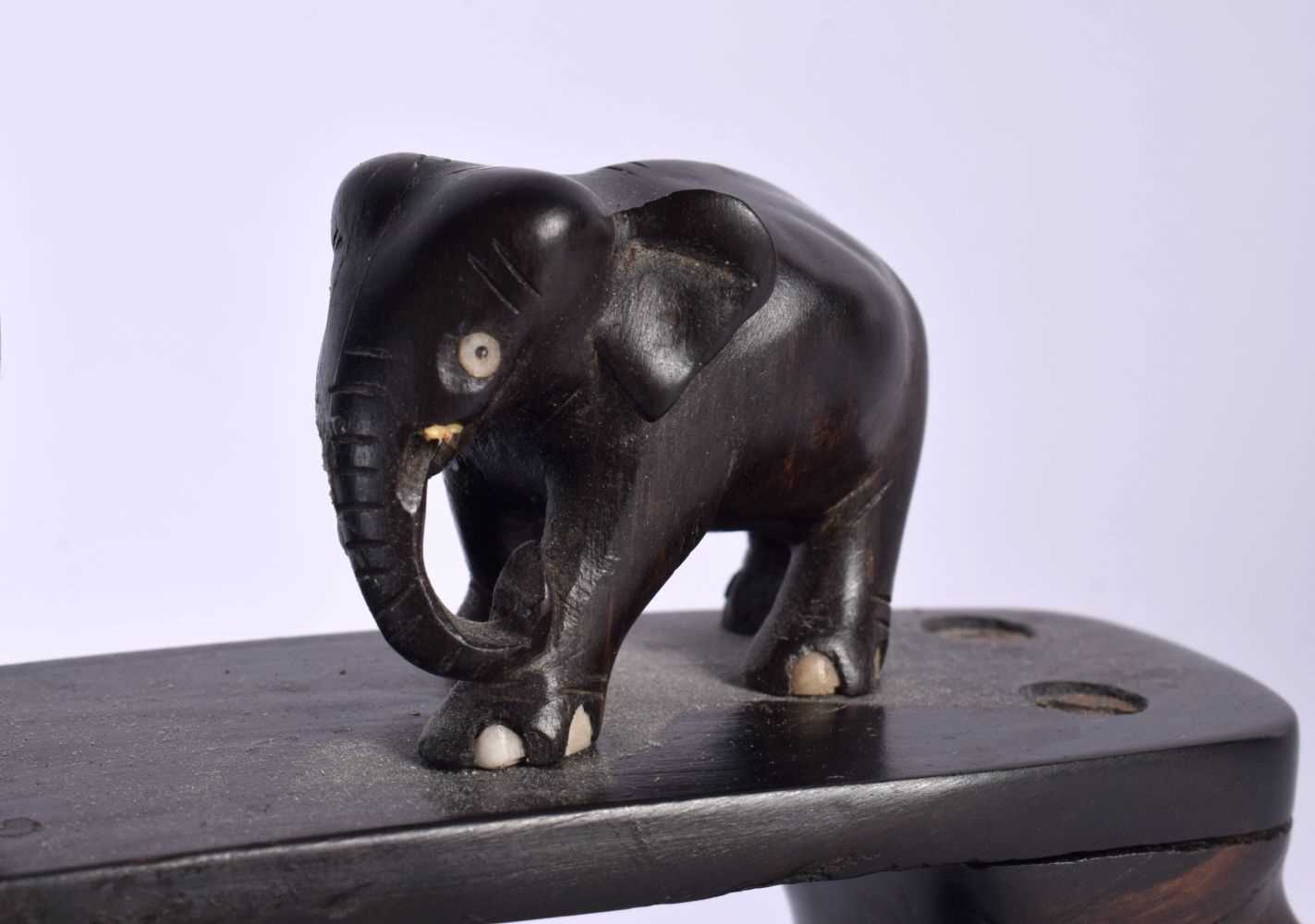 A LATE 19TH CENTURY ANGLO INDIAN CARVED HARDWOOD ELEPHANT GROUP modelled roaming. 45 cm x 20 cm. - Image 4 of 5