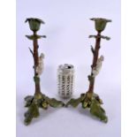 A PAIR OF CONTINENTAL COLD PAINTED BRONZE CANDLESTICKS formed with squirrels climbing on a tree.