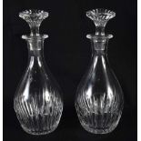A PAIR OF FRENCH BACCARAT GLASS DECANTERS. 16 cm high.