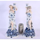 A LARGE PAIR OF LATE 19TH CENTURY GERMAN PORCELAIN CANDLESTICKS formed as figures holding aloft