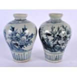 A PAIR OF 19TH CENTURY KOREAN BLUE AND WHITE PORCELAIN VASES painted with flowers. 13 cm high.