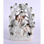 A 19TH CENTURY STAFFORDSHIRE POTTERY FIGURAL GROUP depicting a male and female under a tree. 22 cm x