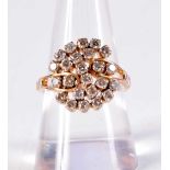 A GOLD AND DIAMOND CLUSTER RING. 5.3 grams. P.