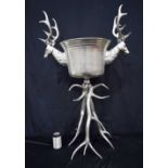 A large metal wine cooler set on a stag antler stand 109 x 68 cm .