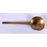 A 17TH CENTURY MIDDLE EASTERN BRASS SPOON. 24 cm long.