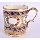 Sevres large coffee can painted with wreaths of flowers and ornately gilded on a cobalt blue