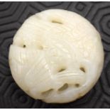 AN EARLY 20TH CENTURY CHINESE CARVED WHITE JADE ROUNDEL Late Qing/Republic. 5.25 cm wide.