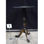 A black lacquered tilt top occasional table with inlay of mother of pearl to the top together with a