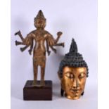A LARGE 19T CENTURY SOUTH EAST ASIAN BRONZE FIGURE OF A DEITY together with a gilded head of a