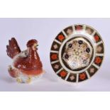 A 19TH CENTURY STAFFORDSHIRE POTTERY HEN TUREEN AND COVER together with a Derby imari plate. Largest